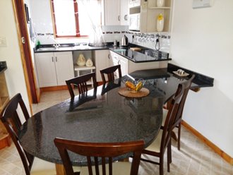 A KITCHEN WITH A LARGE ‘TEARDROP’ GRANITE TOP